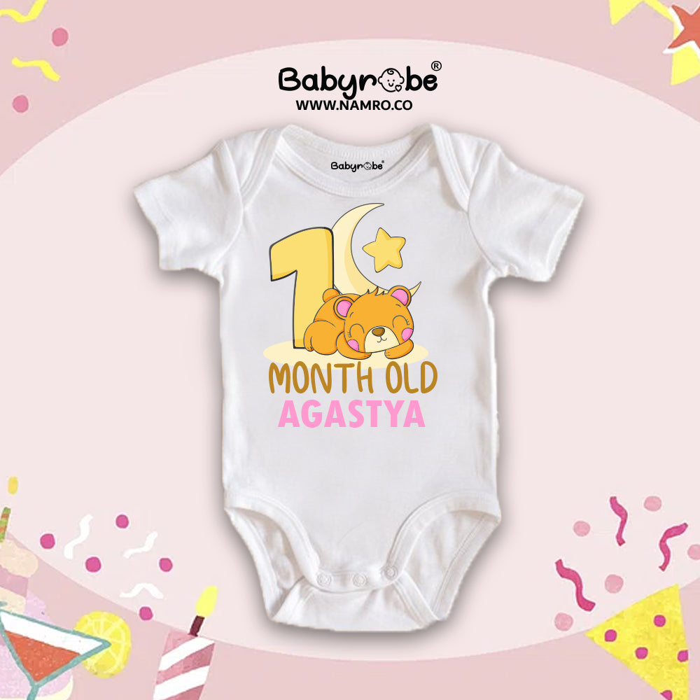"White baby onesie with ‘Olivia’ in pink cursive. Cute custom name baby half romper for first month ."