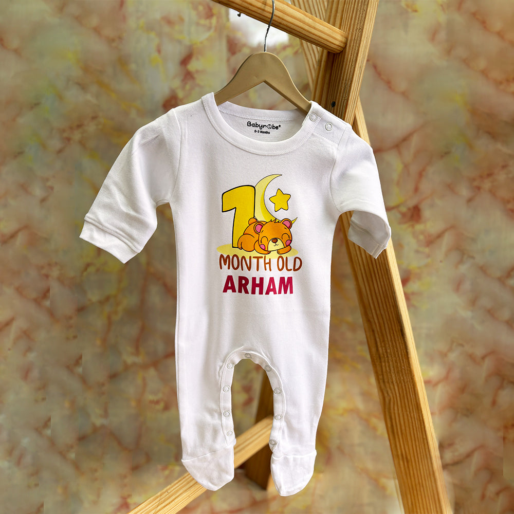 Baby jumpsuit with personalized name for a special first month dress .