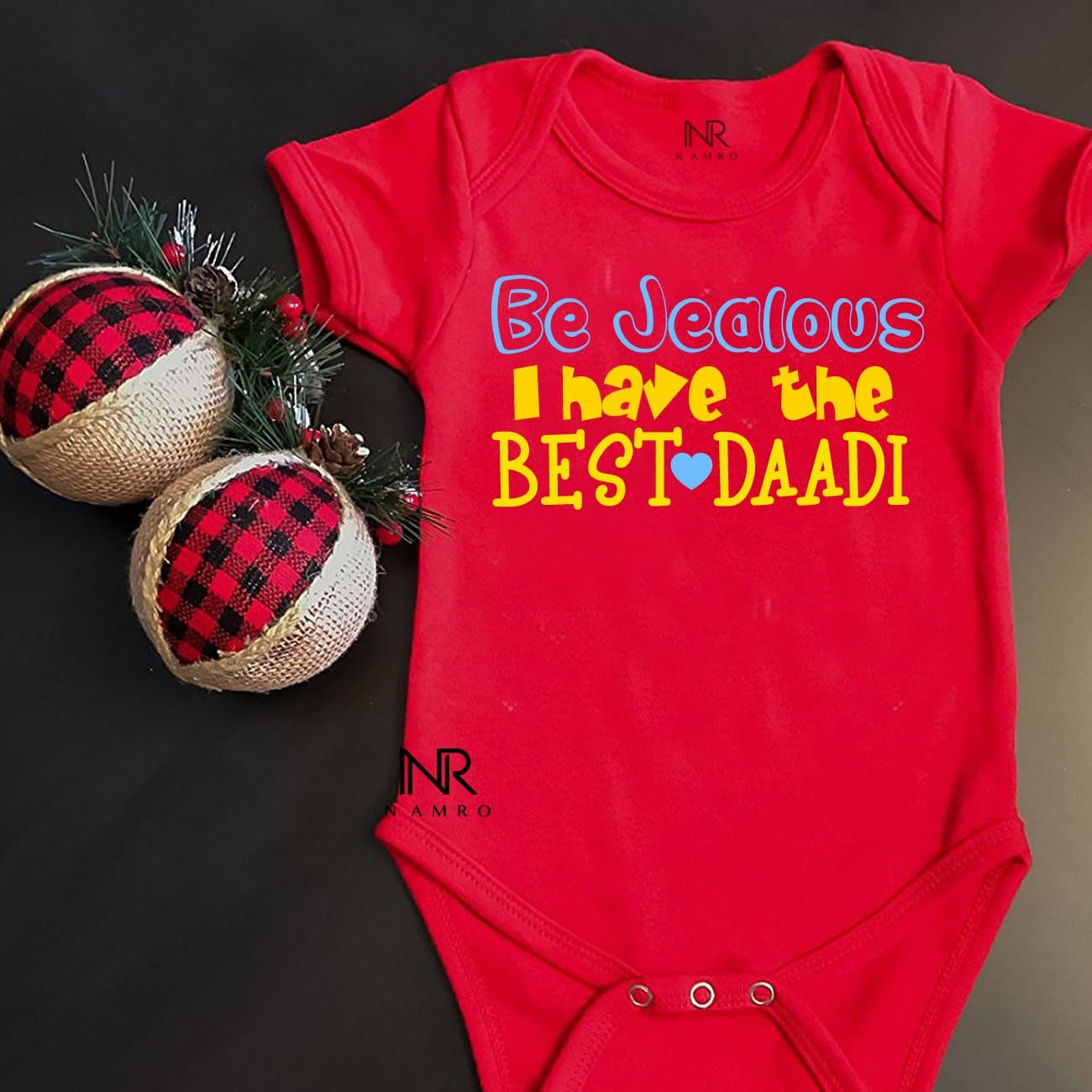 "Personalized baby onesie with custom name and playful design."