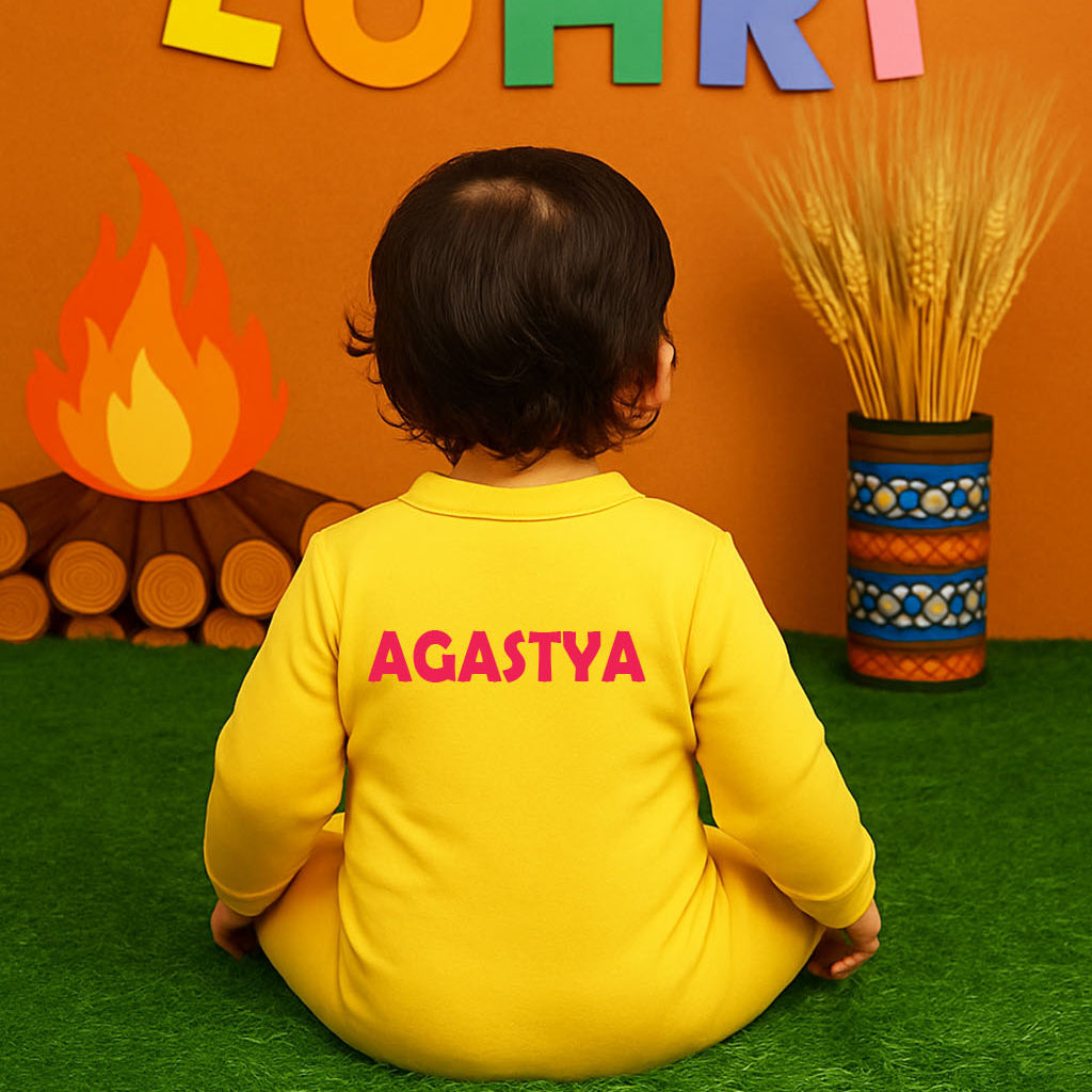Child in a yellow outfit with 'AGASTYA' on it, sitting in front of a colorful 'LOHRI' decoration.
